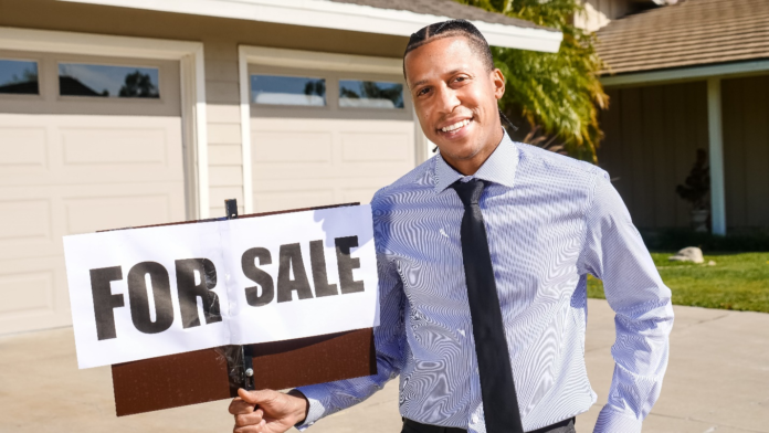 Realtor Realtor Holding a ‘For Sale’ Sign