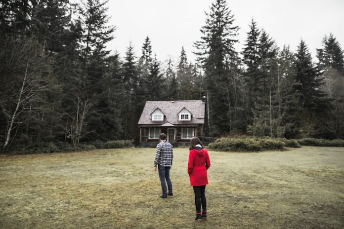 couple-standing-near-forest-shack_23-2147833122